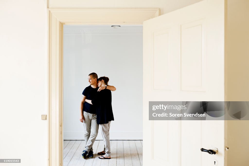 Couple hugging in new home