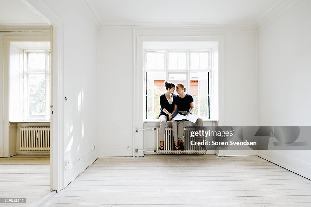 Couple sitting in window of new home