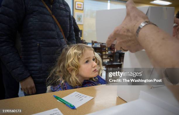 Marta Rose Clark waits with her mom Suzanna Goldblatt Clark to order jelly doughnuts specially made for Hanukkah, at the Kosher Pastry Oven in Silver...