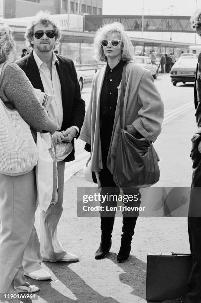 American actress, singer and fashion model Kim Basinger with her husband Ron Snyder-Britton, at Heathrow Airport, London, UK, 12th September 1984.