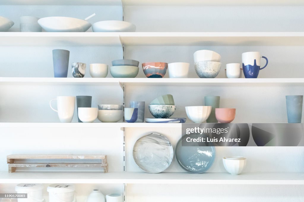 Various earthenware on rack in pottery studio