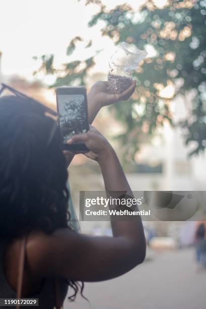 african girl taking picture of nuts - webfluential - fotografias e filmes do acervo