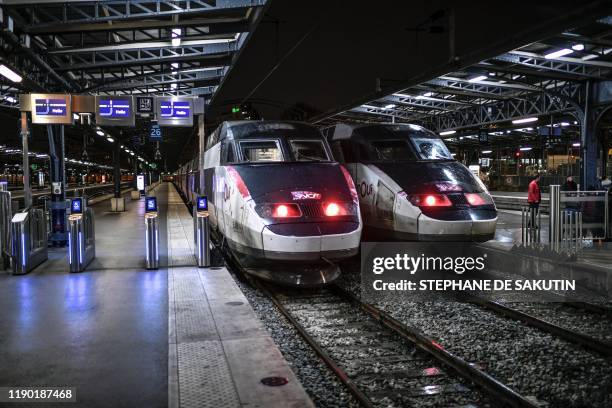 Two TGV trains of the French state railway company SNCF are parked at the platform of the Gare de l'Est train station in Paris on December 23 on the...