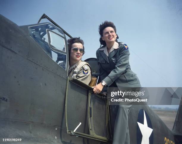 Army promotional photo features Barbara Jane Erickson and Evelyn Sharp , both Women's Auxiliary Ferrying Squadron pilots, as they pose with a North...