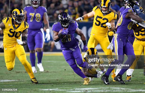 Mark Ingram of the Baltimore Ravens breaks loose from Marqui Christian of the Los Angeles Rams as he runs the ball in the game at the Los Angeles...