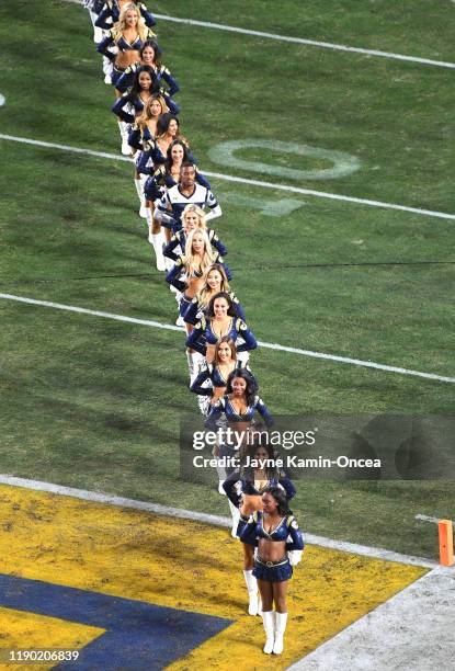 The Los Angeles Rams cheerleaders line up for players to run on to the field for the game against the Baltimore Ravens at the Los Angeles Memorial...