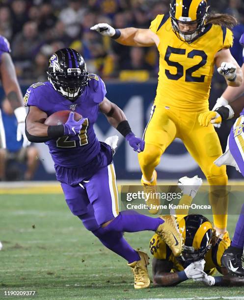 Mark Ingram of the Baltimore Ravens breaks loose from Marqui Christian of the Los Angeles Rams as he runs the ball in the game at the Los Angeles...