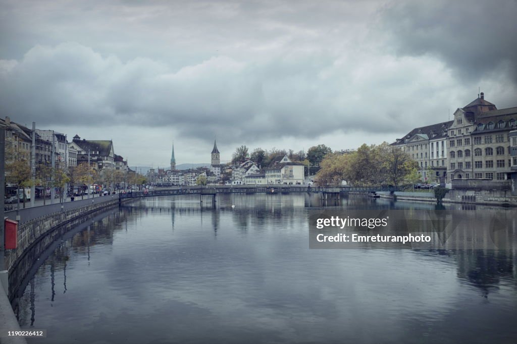 Both sides of Limmat river on a cloudy day.