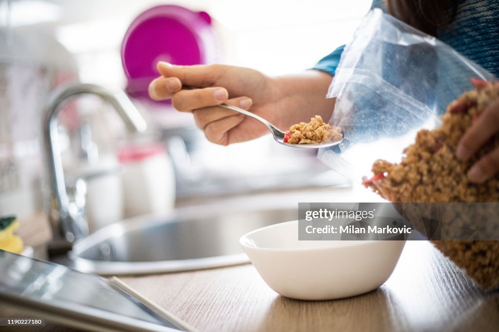 Woman prepares granules for breakfast