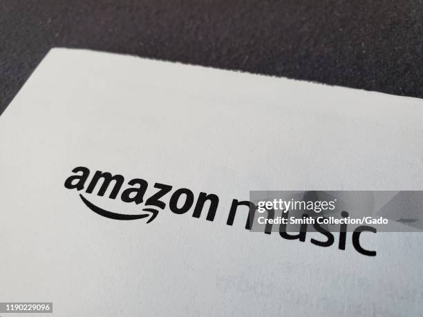 Close-up of logo for Amazon Music, a division of Amazon Prime, on paper on a dark surface, November 25, 2019.