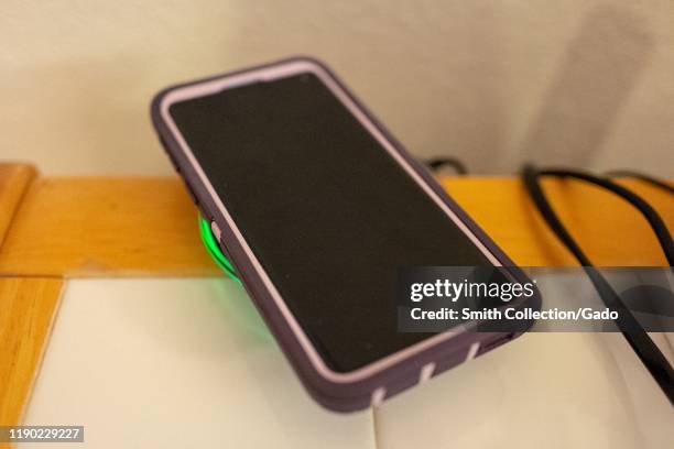 Close-up of a Samsung Galaxy S10 smart phone charging wirelessly on a Samsung charging pad using Qi wireless charging technology, San Ramon,...