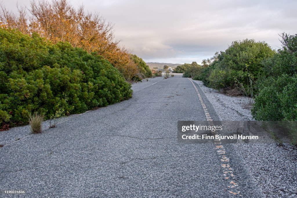 Abandoned with cracks road in Tarifa Spain - Nature taking over
