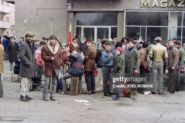 Romanian civilians queue in front of a shop during fights in the streets of Bucharest to overthrow the Socialist Republic of Romania, on December 24...