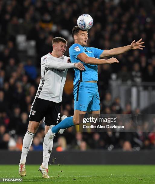 Alfie Mawson of Fulham battles for possession with Chris Martin of Derby County during the Sky Bet Championship match between Fulham and Derby County...