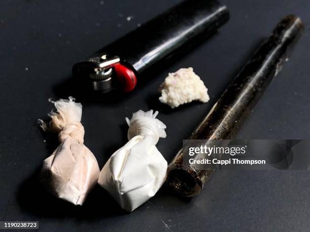 cocaine, heroin, and crack with paraphernalia over a black background - opioid epidemic stock pictures, royalty-free photos & images