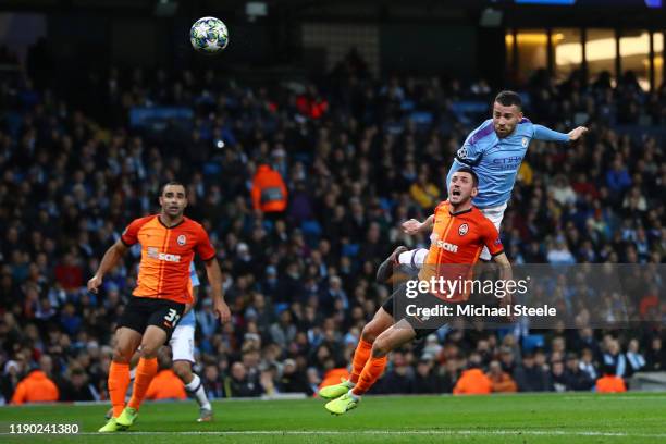 Nicolas Otamendi of Manchester City wins a header under pressure from Serhiy Kryvtsov of Shakhtar Donetsk during the UEFA Champions League group C...
