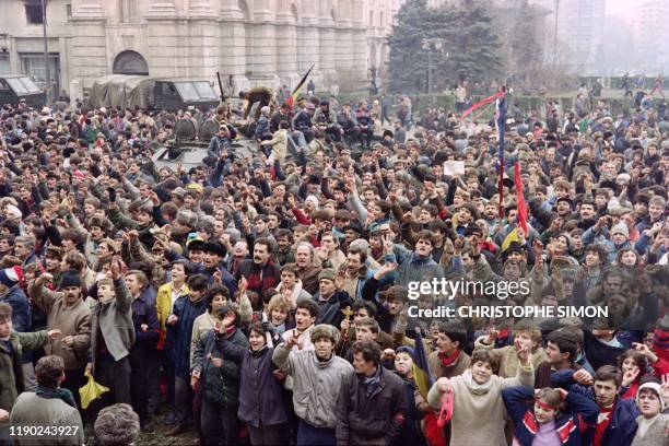 Romanian civilians join the army in a support demonstration to the National Salvation Front Council to overthrow the Socialist Republic of Romania,...