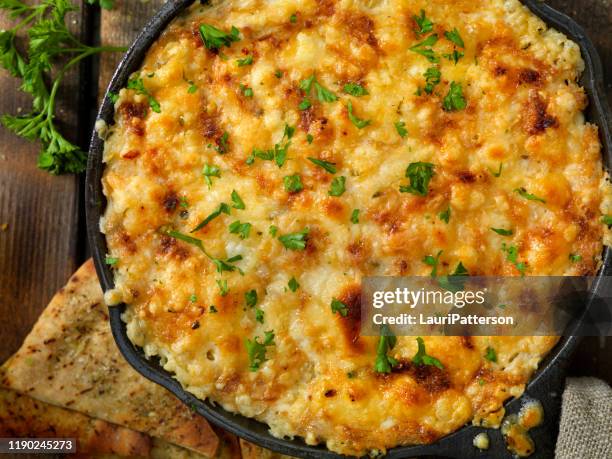 baked artichoke and asiago cheese dip with crispy pita chips - hot spinach dip stock pictures, royalty-free photos & images