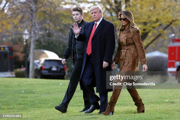 President Donald Trump, first lady Melania Trump and their son Barron Trump walk across the South Lawn before leaving the White House on board Marine...