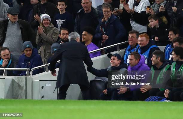 Manager of Spurs Jose Mourinho thanks the ball kid who help set up a goal during the UEFA Champions League group B match between Tottenham Hotspur...