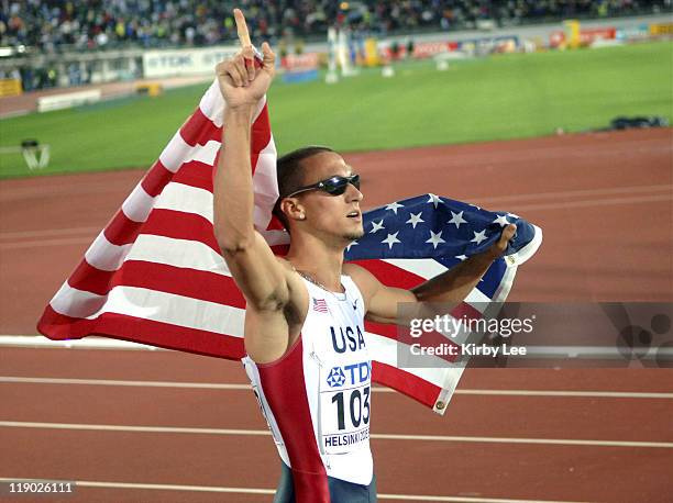 Jeremy Wariner of the United States takes a victory lap wiht American flag after winning the 400 meters in 43.93 in the IAAF World Championships in...
