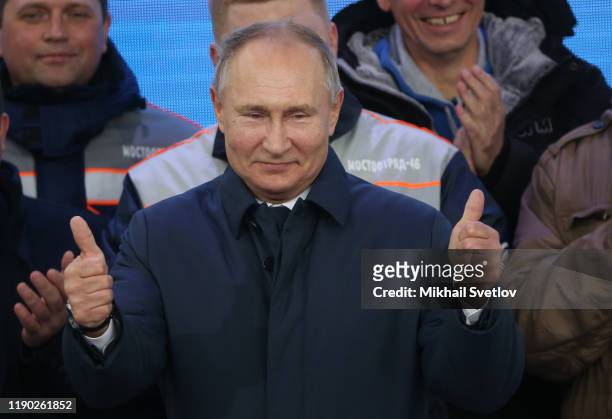 Russian President Vladimir Putin talks during his meeting with workers after riding a train across the bridge linking Russia and Crimean Peninsula at...