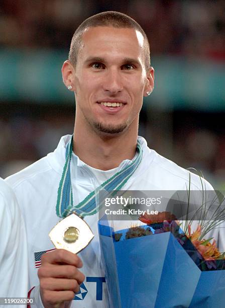 Jeremy Wariner poses with gold medal after anchoring United States 1,600-meter relay to victory in 2:56.91 in the IAAF World Championships in...