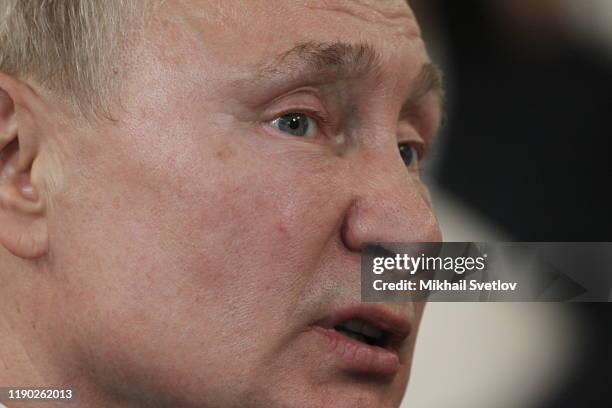 Russian President Vladimir Putin talks while visiting the exhirbition after riding a train across the bridge linking Russia and Crimean Peninsula at...