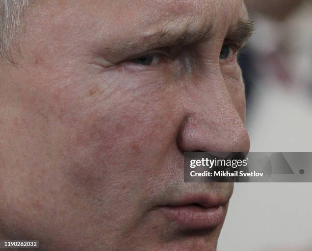 Russian President Vladimir Putin talks while visiting the exhirbition after riding a train across the bridge linking Russia and Crimean Peninsula at...