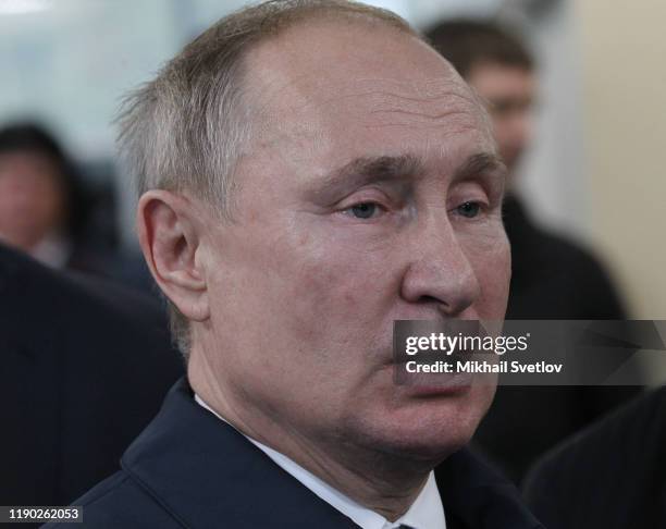 Russian President Vladimir Putin talks while visiting the exhirbition after riding a train across the bridge linking Russia and Crimean Peninsula at...