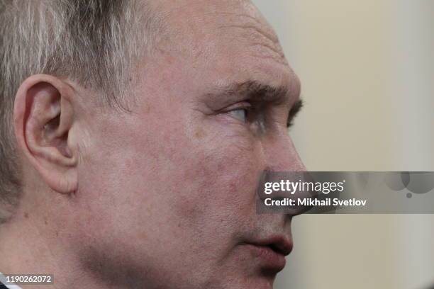 Russian President Vladimir Putin talks while visiting the exhirbition after riding a train across the bridge linking Russia and Crimean Peninsula at...