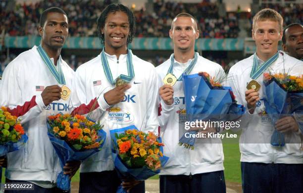 The United States 1,600-meter relay of Derrick Brew, Darold Williamson, Jeremy Wariner and Andrew Rock pose with gold medals after winning in 2:56.91...