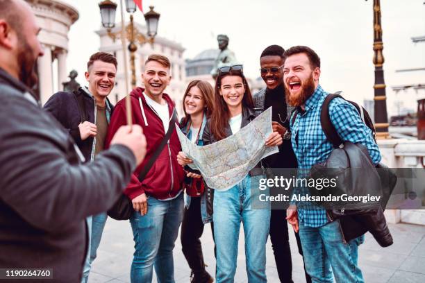 tour guide showing city to new tourists - travel guidance stock pictures, royalty-free photos & images