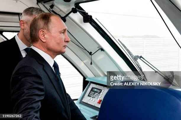 Russian President Vladimir Putin rides a train connecting the Crimea to mainland Russia in Kerch on December 23, 2019. - The Russian Presdient on...