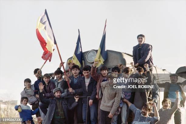 Romanian brandish the national flag on a Suburban train in the border town of Oravita, on December 22 as the anti-Communist uprising to end Nicolae...