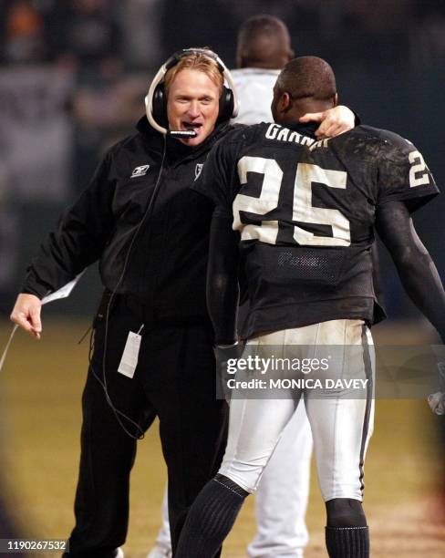 Oakland Raiders head coach Jon Gruden greets Raiders runningback Charlie Garner after Garner ran an 80-yard, fourth-quarter touchdown against the New...