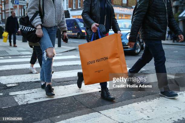 Christmas shoppers carry shopping bags on Marylebone High Street on December 23, 2019 in London, England. There are just two days left until...
