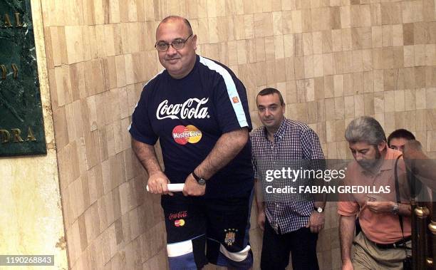Head coach of the Uruguayan soccer team, Victor Pua is trailed by reporters as he makes his way to a press conference in Medellin, Colombia, 15 July...