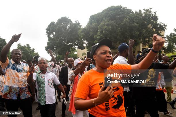 Supporters of the Generations et peuples solidaires political party demonstrate in front of the party headquarters in Abidjan on December 23 after...