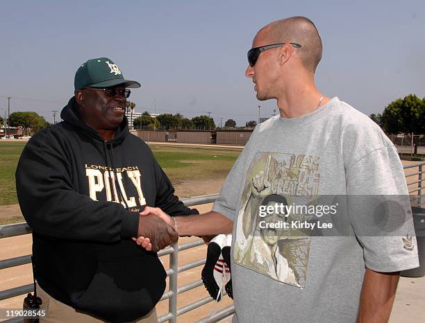 Jeremy Wariner, the 2004 Olympic gold medallist in the 400 meters, shakes hands with Long Beach Poly High School coach Don Norford in Long Beach,...