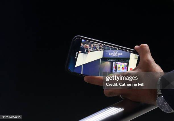 Fan films the team in the tunnel on his mobile phone ahead of the UEFA Champions League group B match between Tottenham Hotspur and Olympiacos FC at...