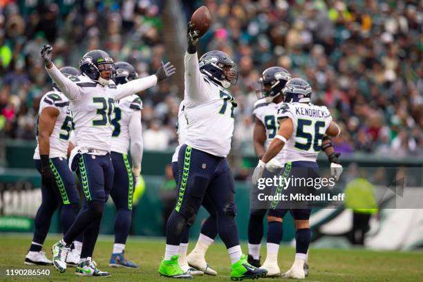 Al Woods, Bradley McDougald, and Mychal Kendricks of the Seattle Seahawks react after a fumble recovery against the Philadelphia Eagles at Lincoln...