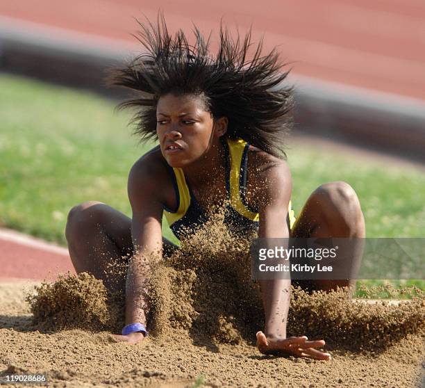 Amber Purvis of Benicia lands in the sand pit during the girls' long jump in the CIF State Track & Field Championships at Hughes Stadium in...