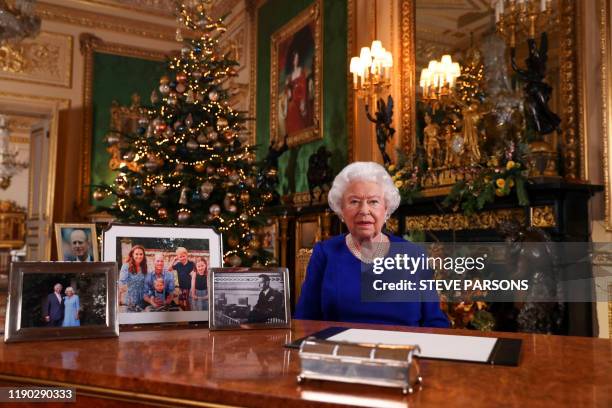Picture released on December 24, 2019 shows Britain's Queen Elizabeth II posing for a photograph after she recorded her annual Christmas Day message,...