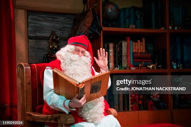 Santa Claus poses at his office near Rovaniemi, Finnish Lapland, on December 2, 2019. - Rovaniemi's Santa Claus Village amusement park is a...