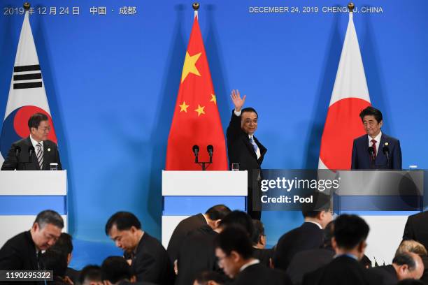China's Premier Li Keqiang waves as he leaves a joint press conference with Japan's Prime Minister Shinzo Abe and South Korea's President Moon Jae-in...