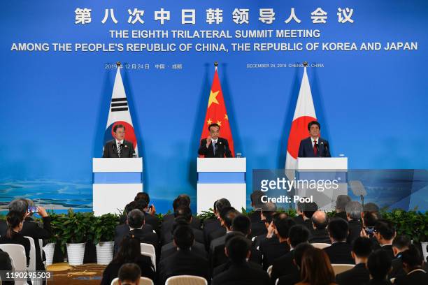 China's Premier Li Keqiang speaks at a joint press conference with Japan's Prime Minister Shinzo Abe and South Korea's President Moon Jae-in at the...
