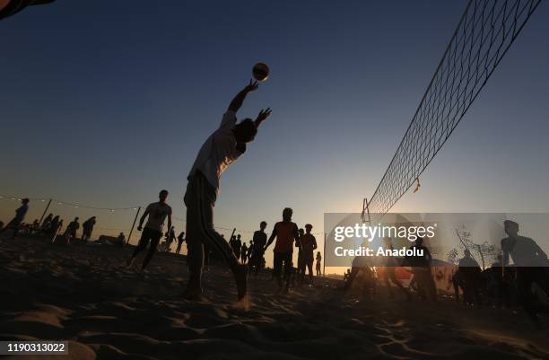 Iraqi youth play volleyball at Tahrir beach in Baghdad, Iraq on December 23, 2109. Young protesters in Baghdad, continue to protest the government...