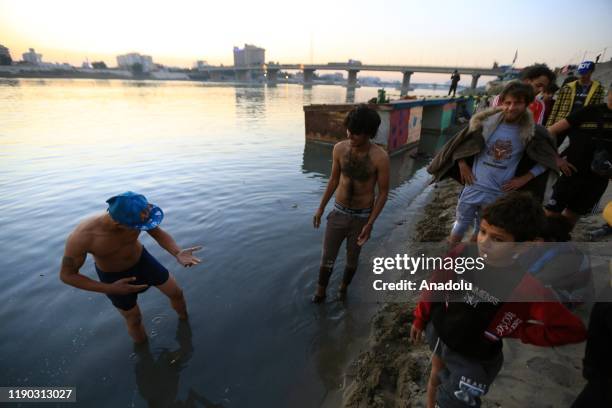 Iraqi youth enjoy at Tahrir beach in Baghdad, Iraq on December 23, 2109. Young protesters in Baghdad, continue to protest the government and also...