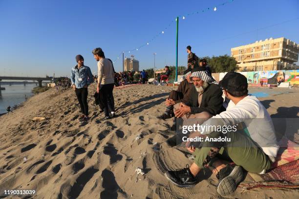 Iraqi youth enjoy at Tahrir beach in Baghdad, Iraq on December 23, 2109. Young protesters in Baghdad, continue to protest the government and also...